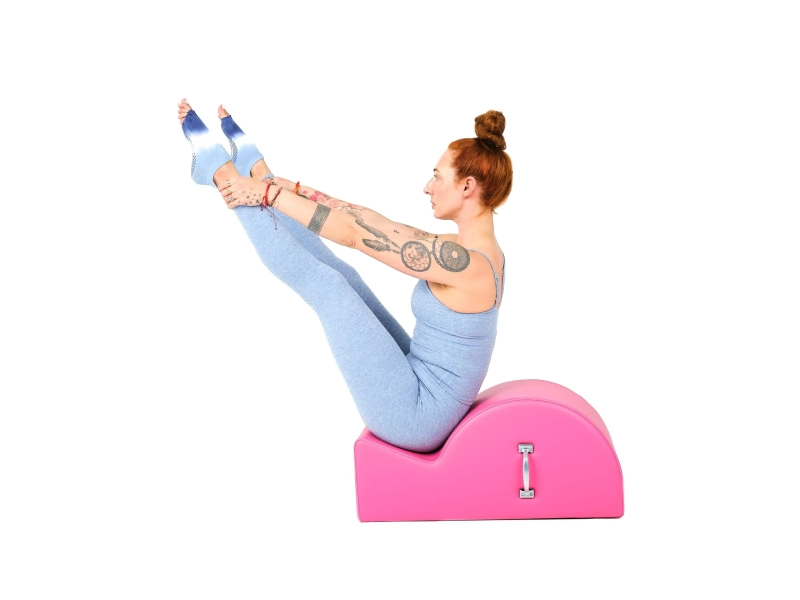 In addition to being performed on a mat, the Open Leg Rocker can also be performed on a Spine Corrector.