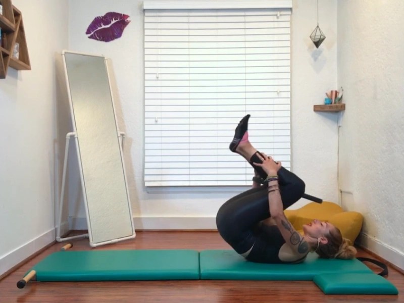 Perform the Rolling Like a Ball exercise with the Pilates hoop.