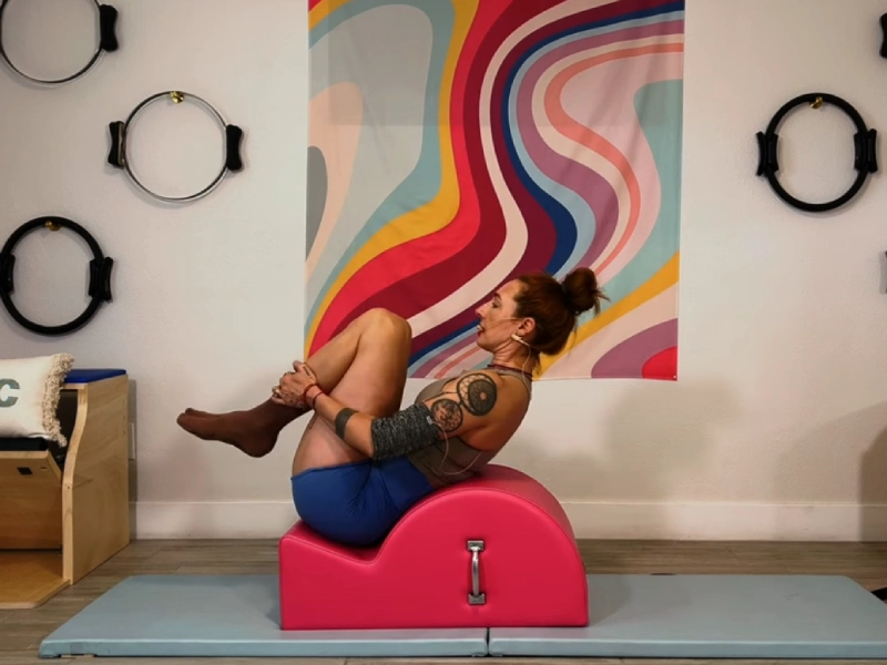 Steps to perform the Pilates Rolling Like a Ball exercise on a Spine.