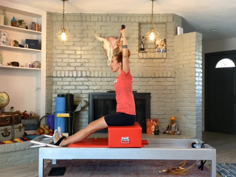 Steps to perform the Pilates Flat Back exercise on a Reformer.