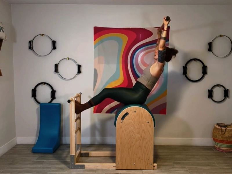 Perform the Pilates Flat Exercise on the Ladder Barrel.