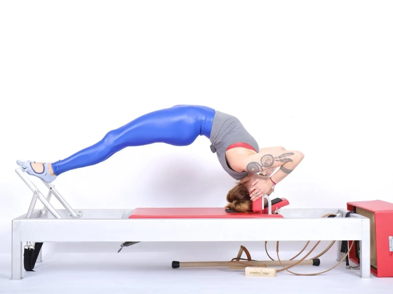 Pilates Headstand Facing Up exercise on the Reformer.