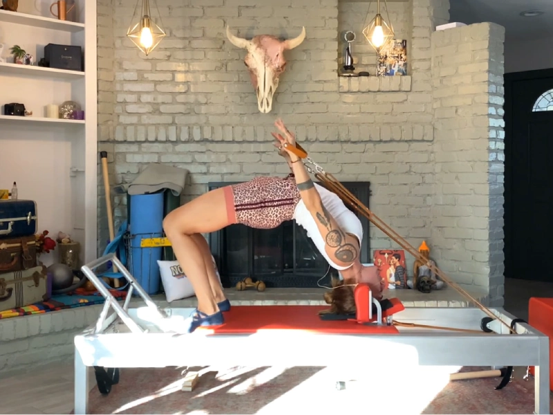 Instructions for performing Pilates Headstand with Straps on a Reformer.