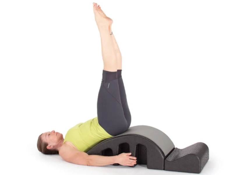 Steps to perform Pilates Helicopter exercises on a Spine Corrector.
