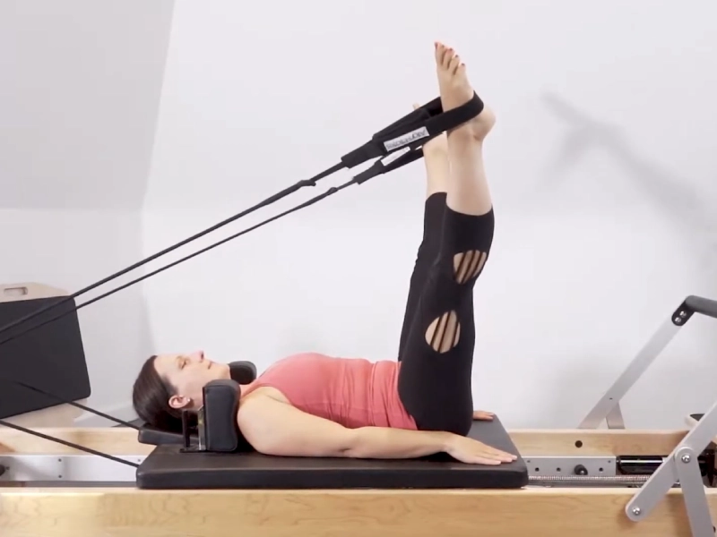 Perform Pilates Leg Circles on the Reformer.