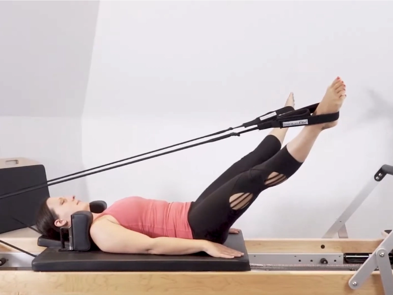 Perform Pilates Leg Circles on the Reformer.