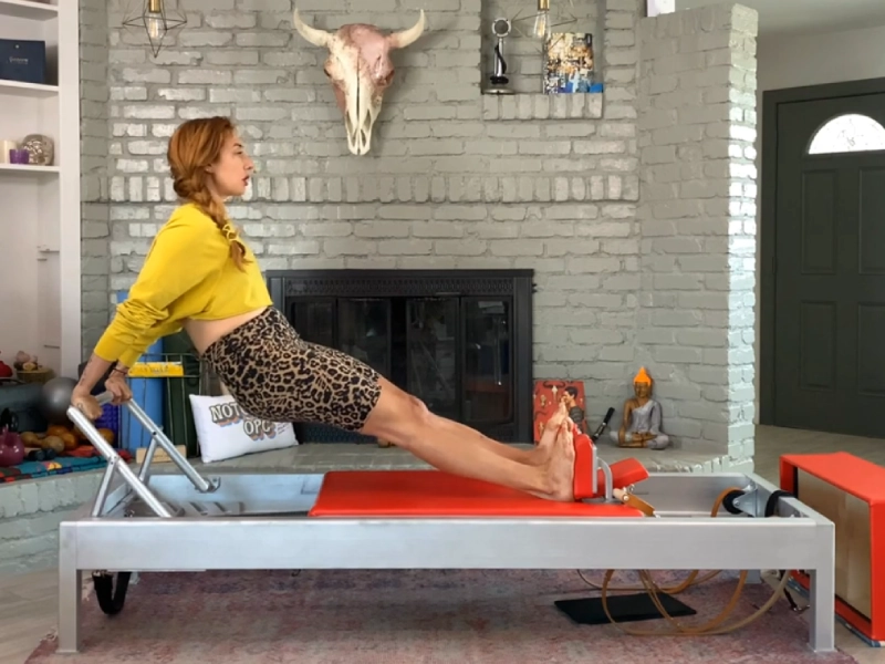 How to perform the Pilates Long Back Stretch exercise on a Reformer.