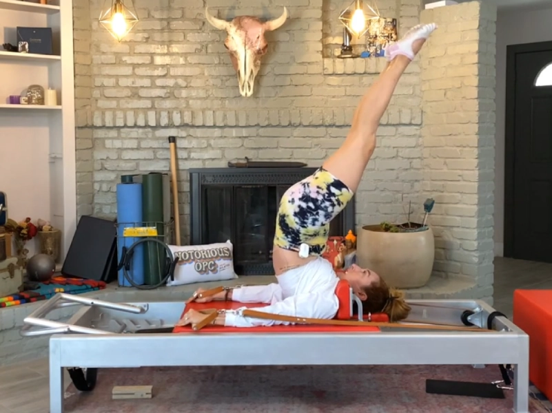 perform the Pilates Overhead exercise on the Reformer.