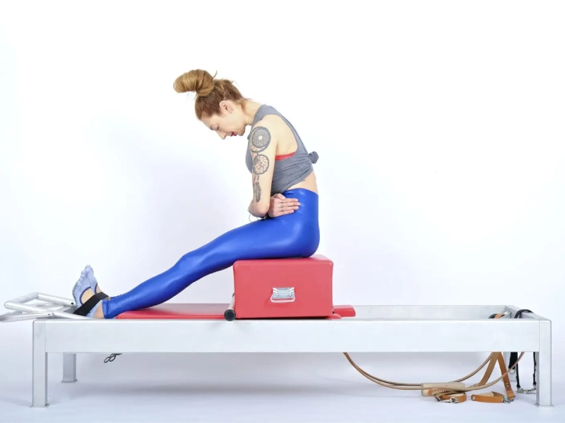 Pilates Round Back Exercise on the Reformer.