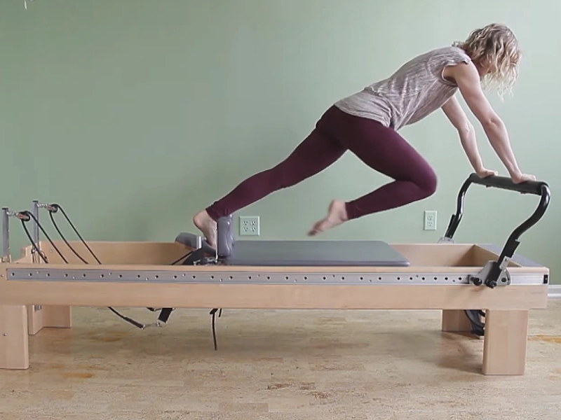 The Single Leg Knees Off exercise on the Reformer helps strengthen leg muscles.
