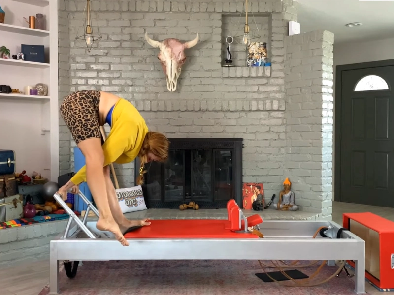 Steps to perform the Pilates Single Leg Tendon Stretch exercise on a Reformer.