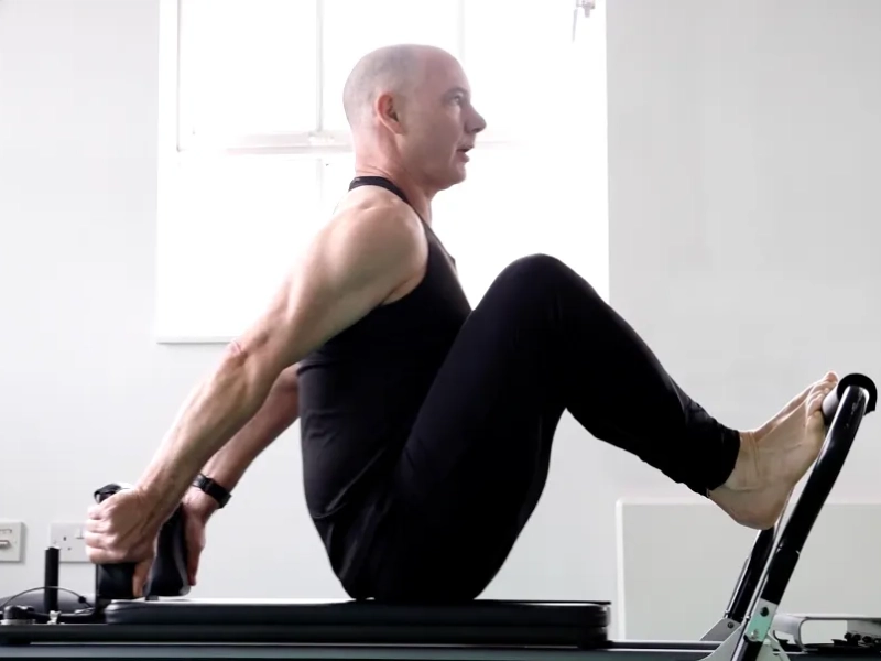 Benefits of Stomach Massage Hands Back on the Reformer machine.