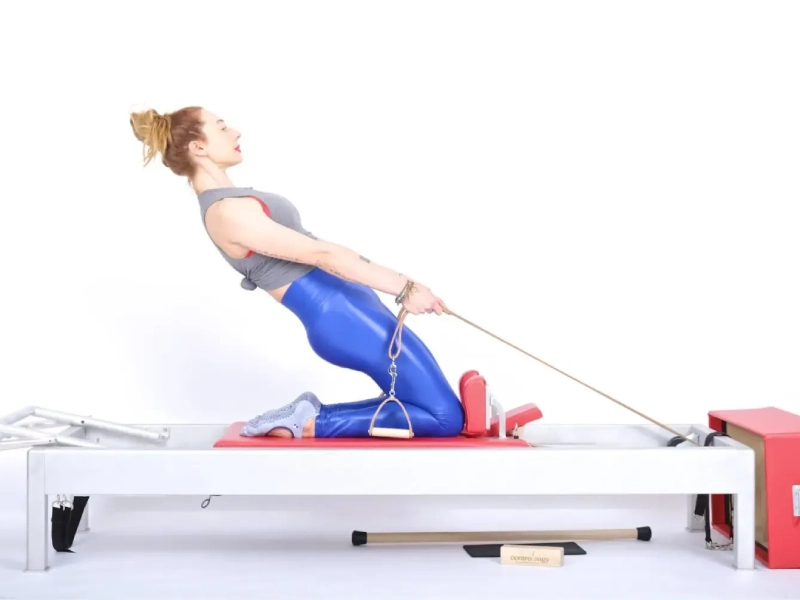 The Thigh Stretch exercise when performed on the Reformer machine.