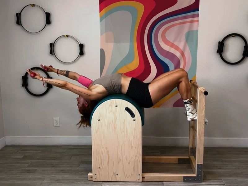 Performing the Pilates Circles Exercise on the Ladder Barrel.