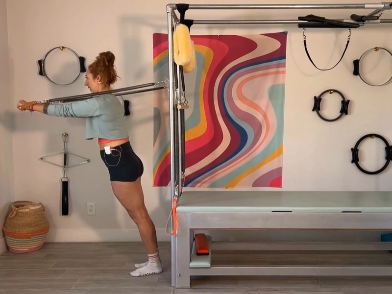 This is the posture for performing Pilates Boxing with Standing Arm Springs on a Cadillac.