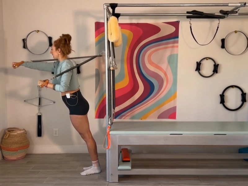 This is the posture for performing Pilates Boxing with Standing Arm Springs on a Cadillac.