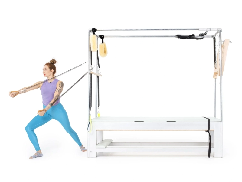Pilates Fencing with Standing Arm Springs on the Cadillac helps improve posture and balance.