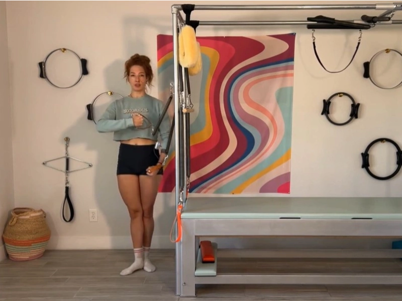 Steps to perform the Pilates Fencing with Standing Arm Springs exercise on the Cadillac.