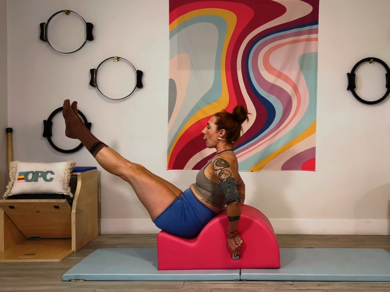 Perform Pilates Hip Circles on the Spine Corrector