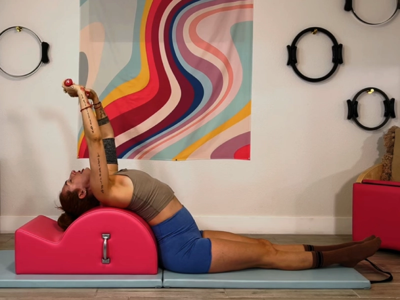 Steps to perform the Pilates Hug on the Spine Corrector.