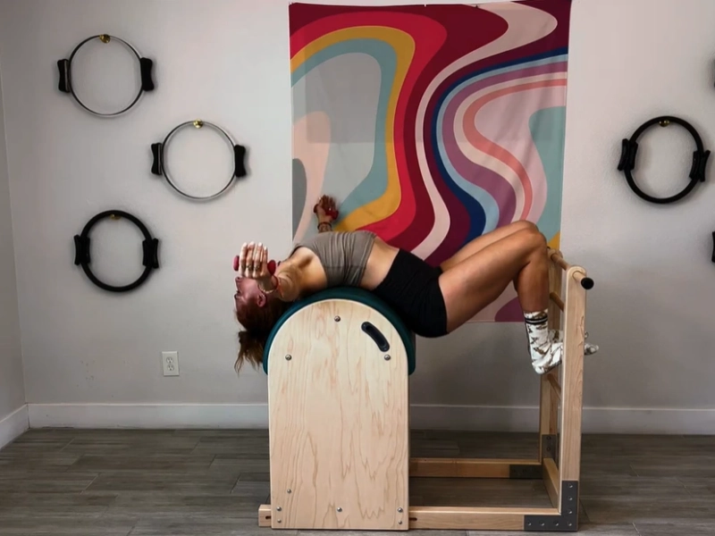 Steps to perform the Pilates Hug on the Ladder Barrel.
