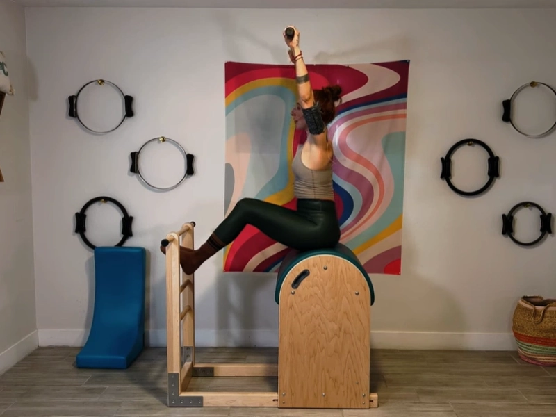 Perform the Pilates Side to Side on Ladder Barrel.