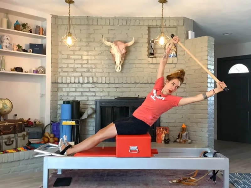 Pilates Twist and Reach exerciseon on the Reformer.
