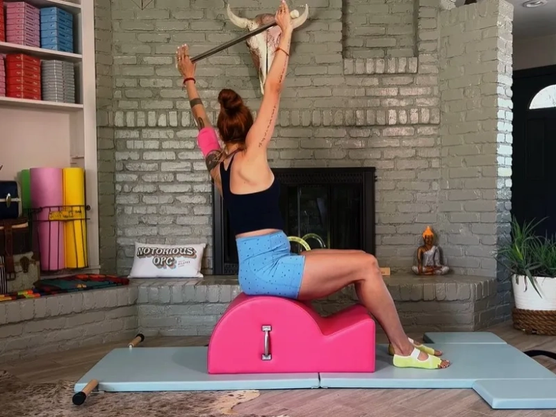 Pilates Twist and Reach exerciseon on the Spine Corrector.